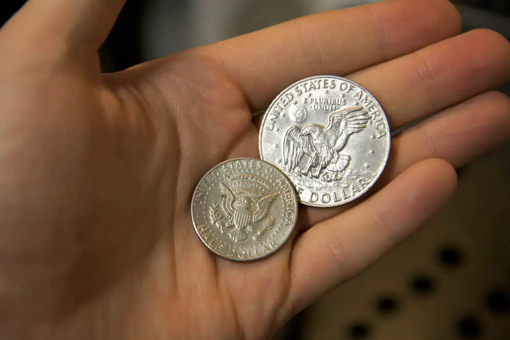 holding a SILVER HALF DOLLARS