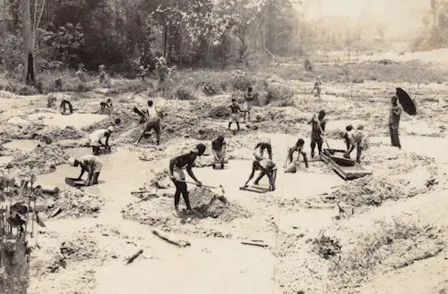 old image of group of people mining for gold