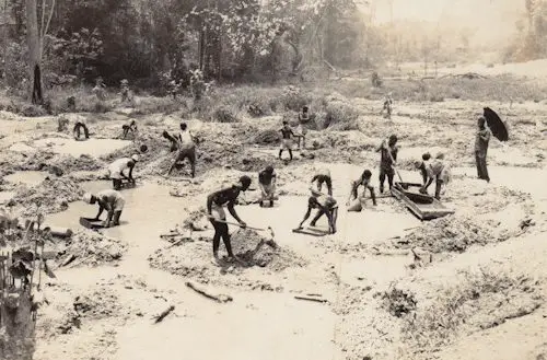 people using old gold mining equipment